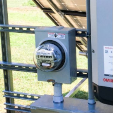 Utility meter mounted on the back of a solar array.