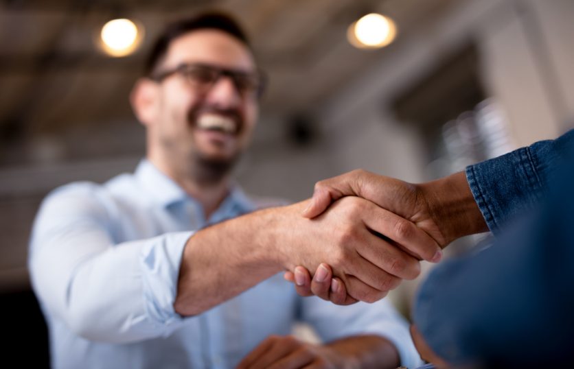 two individuals shaking hands