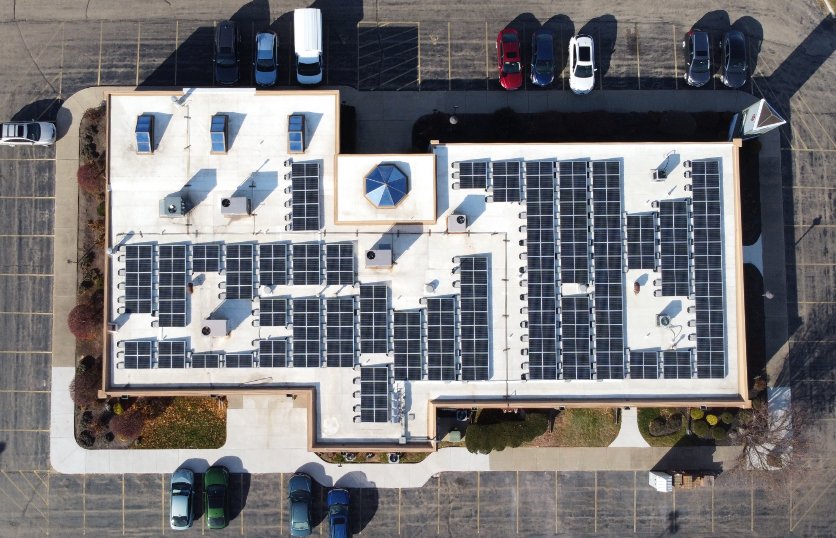 Aerial view of a business office with solar panels on the roof