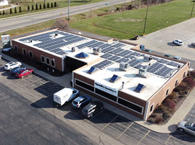 Small sustainable office building with solar panels on the roof