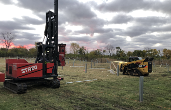 Nelnet Renewable Energy pile driver and bobcat machine. 