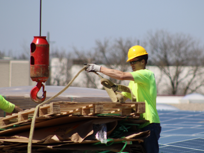 Solar installer cleaning up a work site.