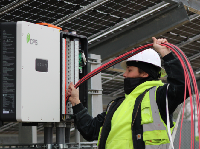 solar installer pulling wiring through conduit piping.