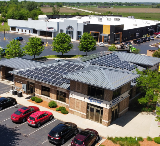 A local bank with solar panels installed on its metal roof.