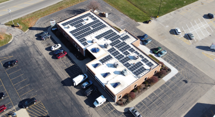 Commercial business with solar panels on their flat roof.