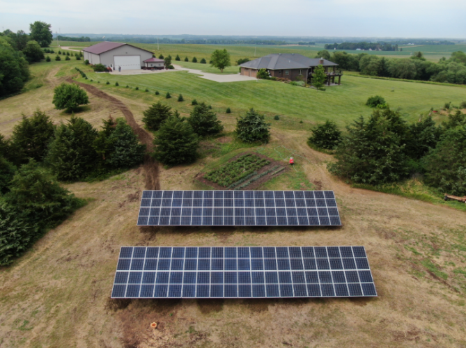 A picturesque countryside home adorned with solar panels, capturing clean energy from the sun.